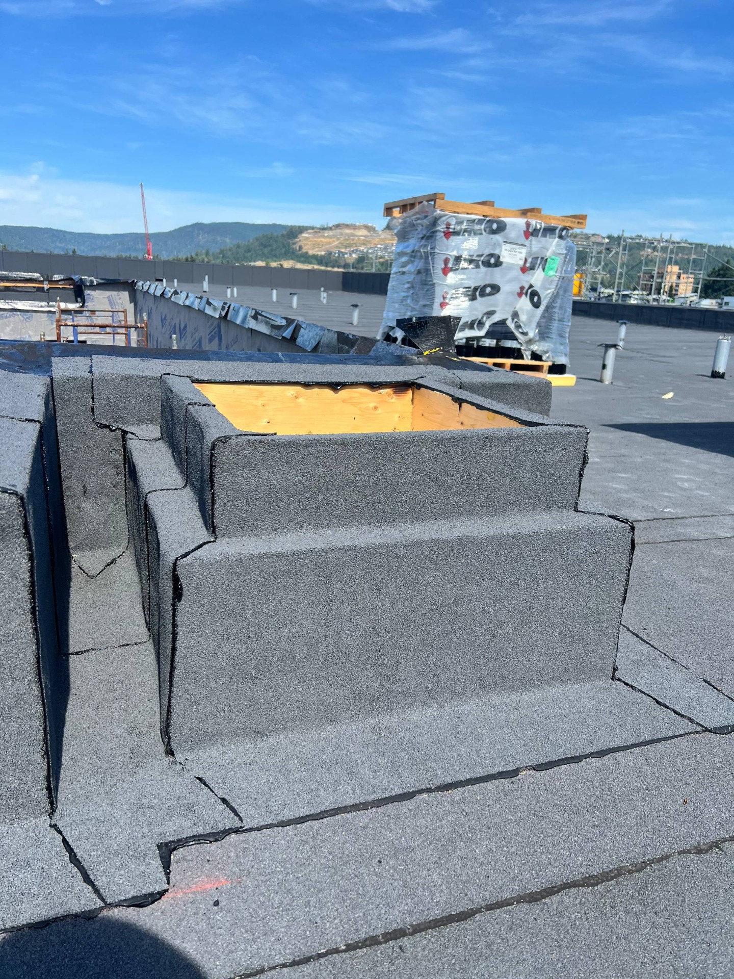Membrane wrapped around a curb with exposed framing